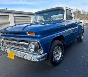 Blue and white vintage Chevrolet pickup truck parked outdoors.