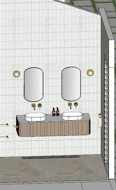 Bathroom with two oval mirrors, sinks, and gold fixtures against a tiled wall.