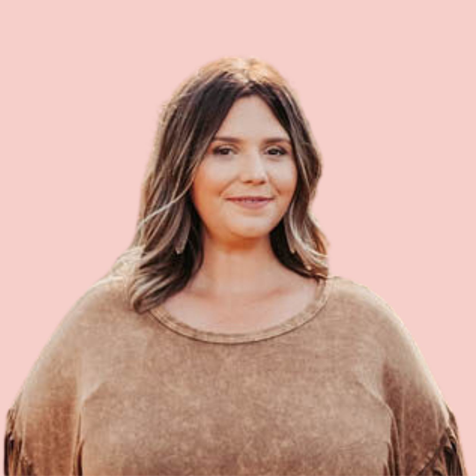 a woman in a brown sweater is standing in front of a pink background .