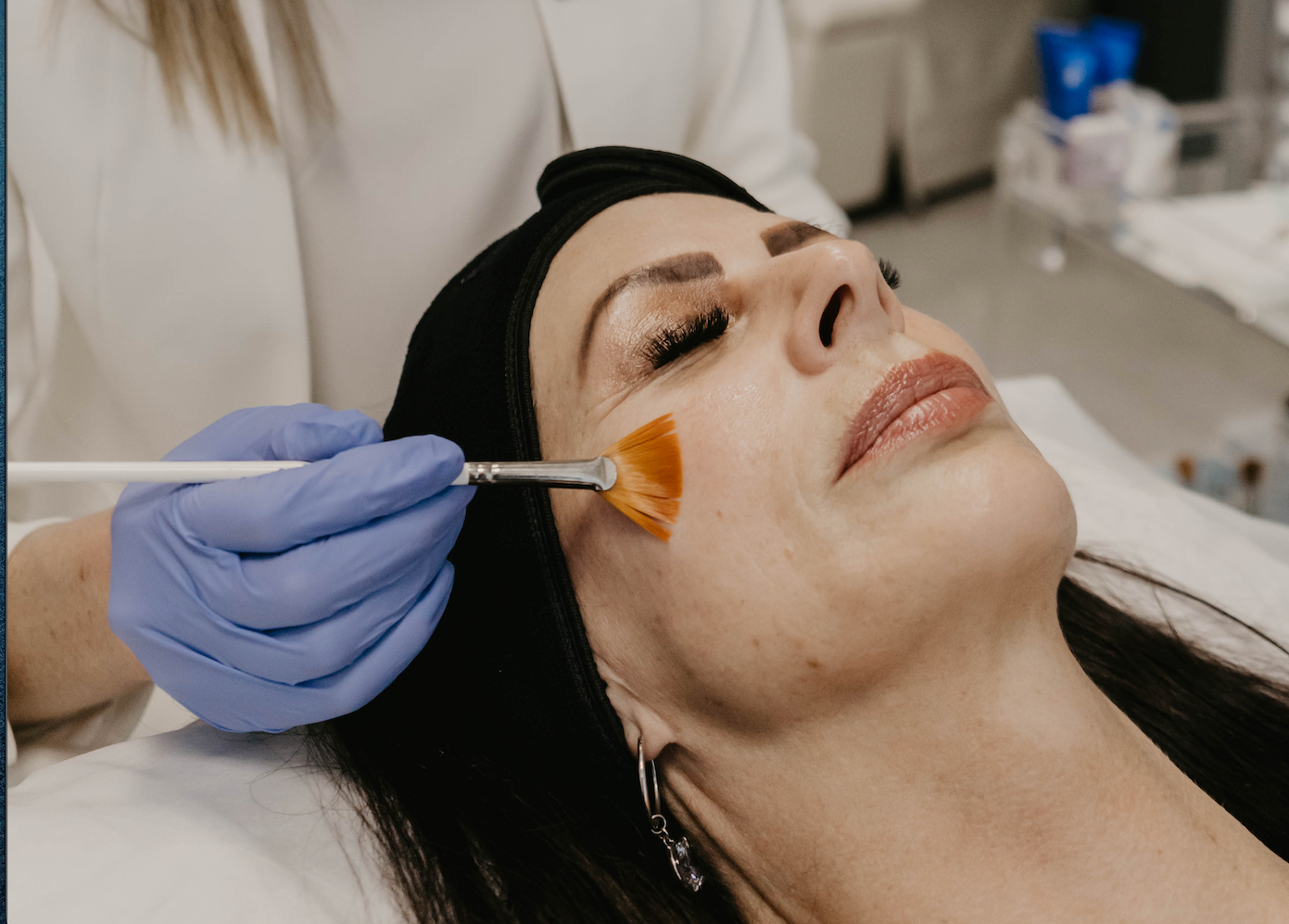 A woman is getting a facial treatment at a beauty salon.