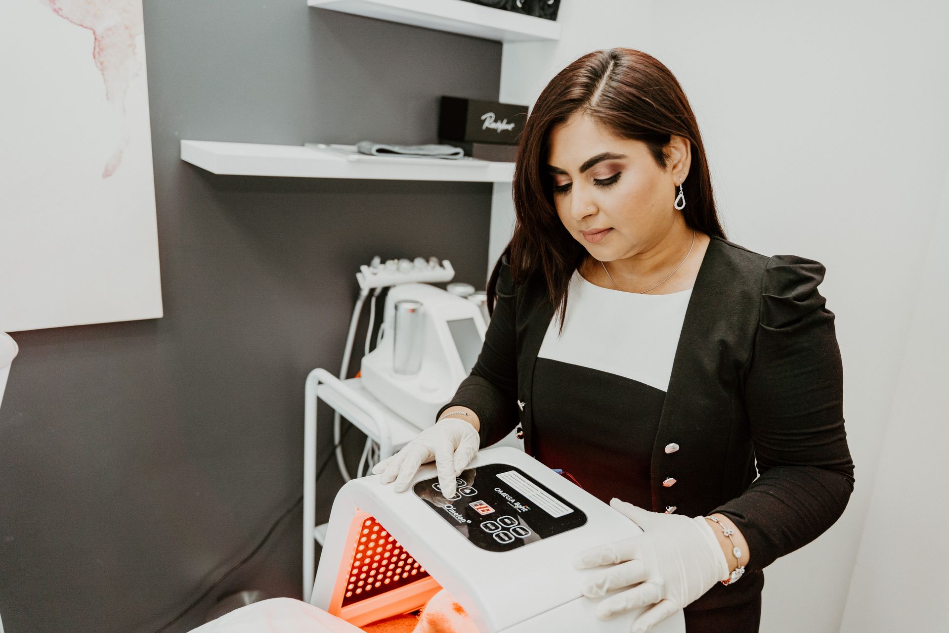 A woman is holding a machine in a beauty salon.