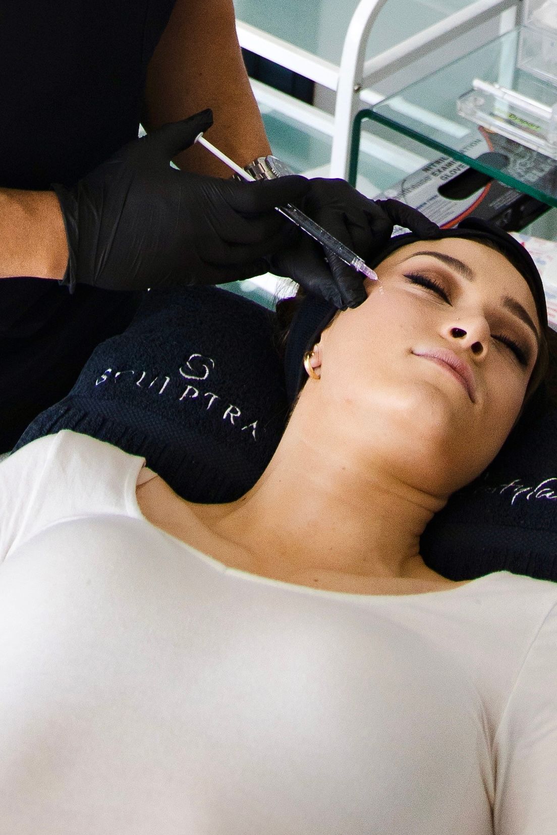 A woman is getting a botox injection in her neck.