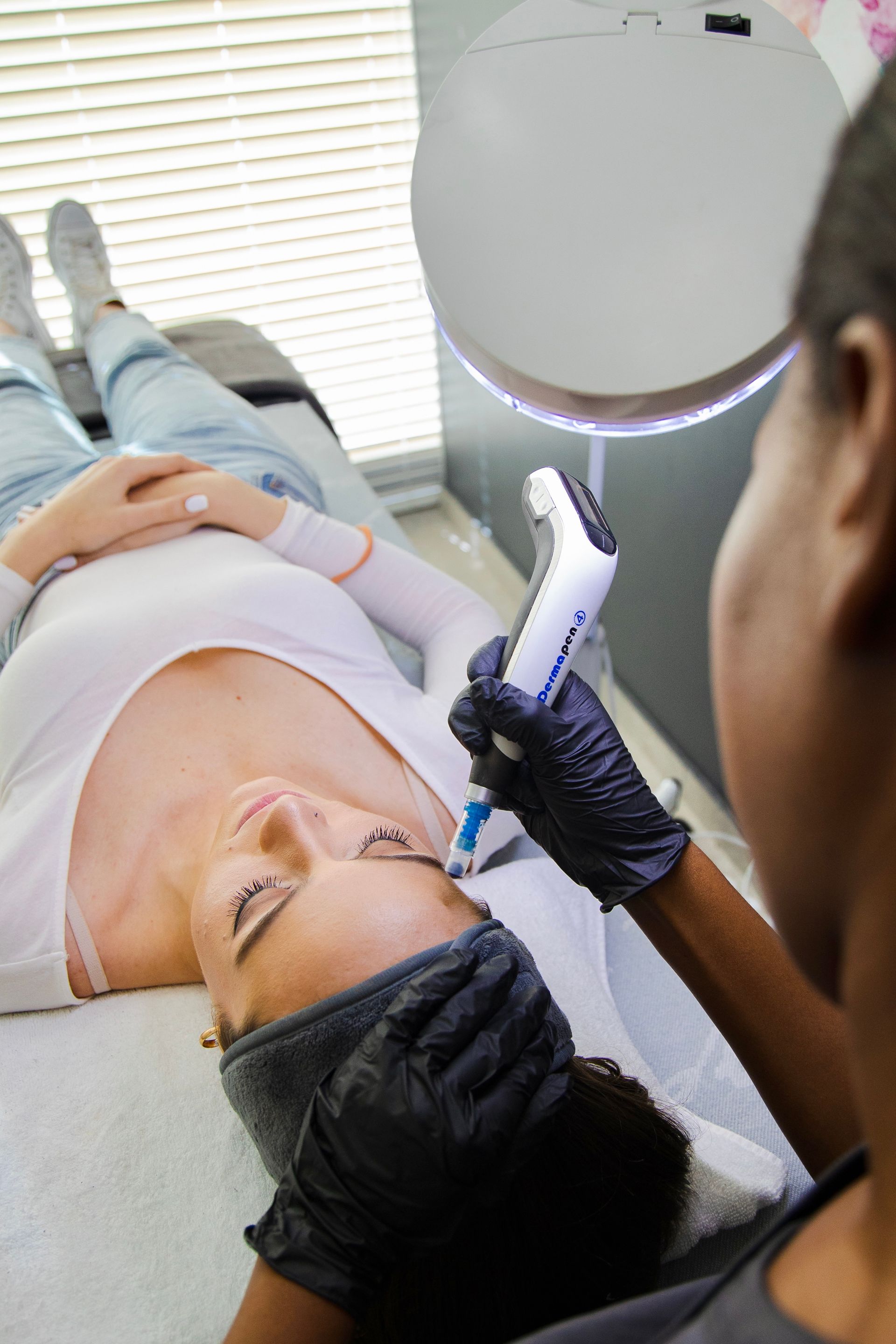 doctor micro-needling a woman's eyebrow area