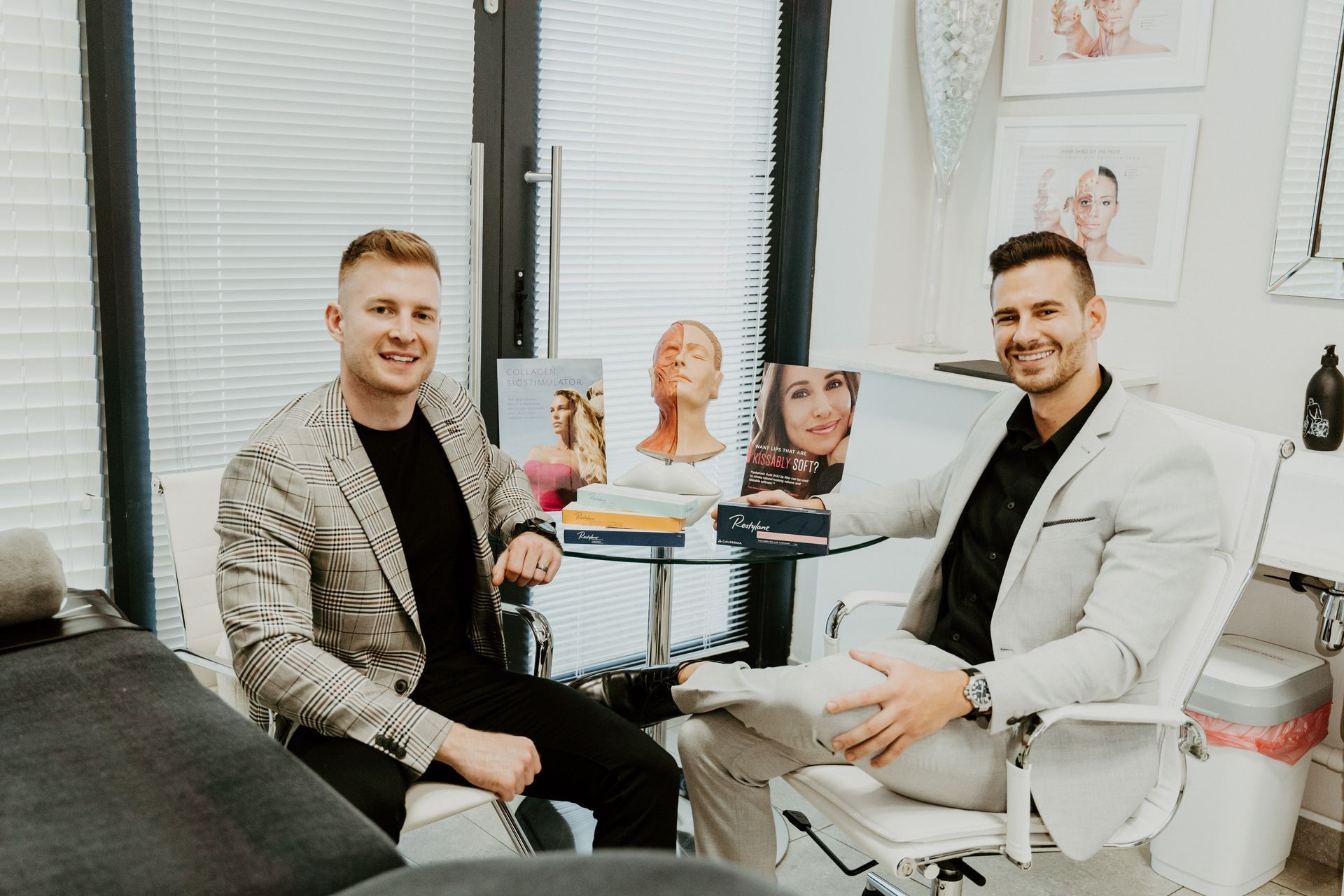 Two men are sitting in chairs in a room.
