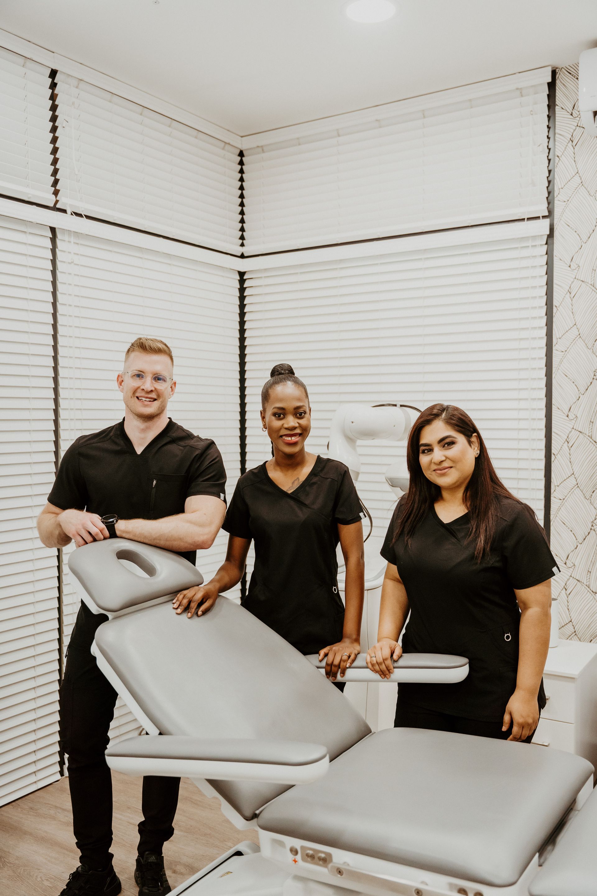 A group of people are standing next to each other in a room.