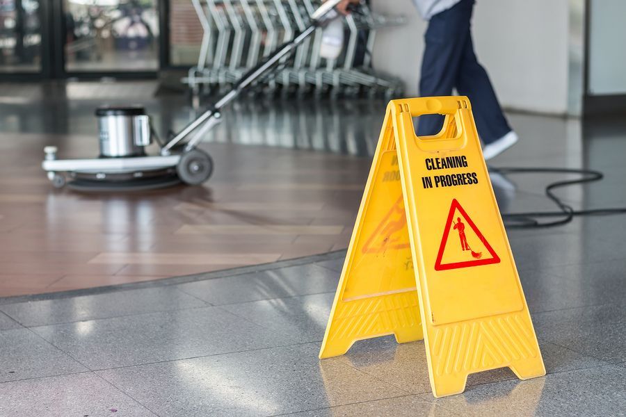 a yellow caution sign sitting on top of a floor