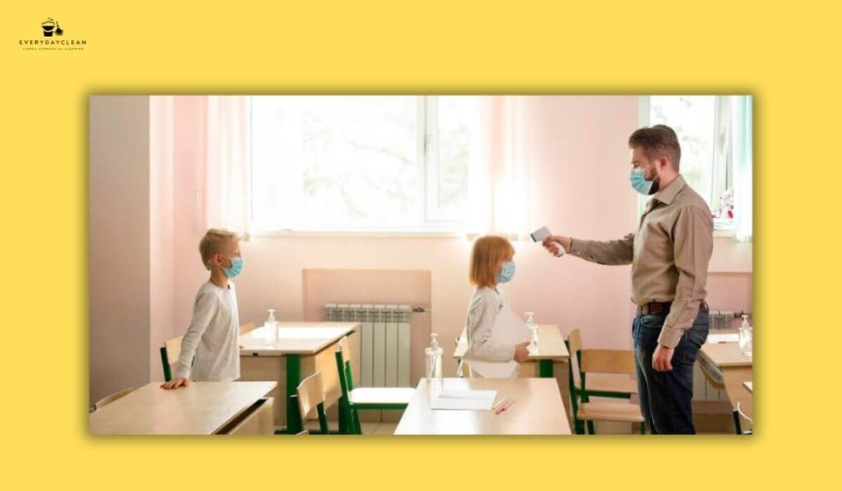 Teacher sanitising playroom surfaces for children’s safety