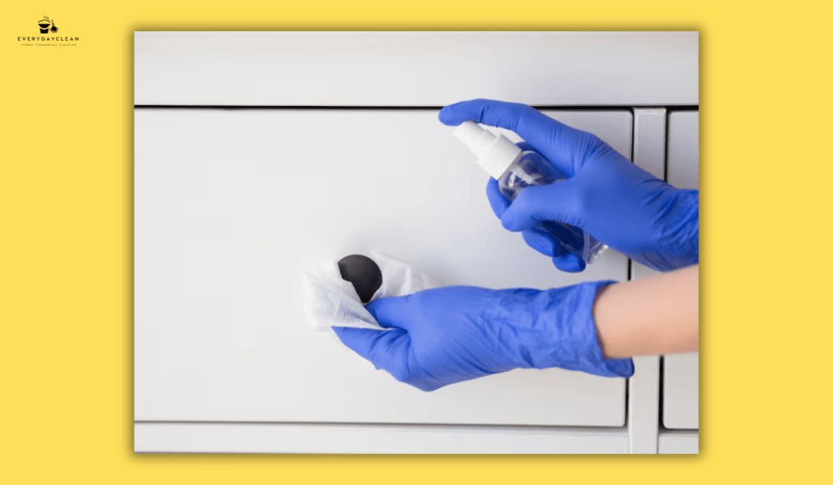 cleaner wearing gloves disinfecting the office
