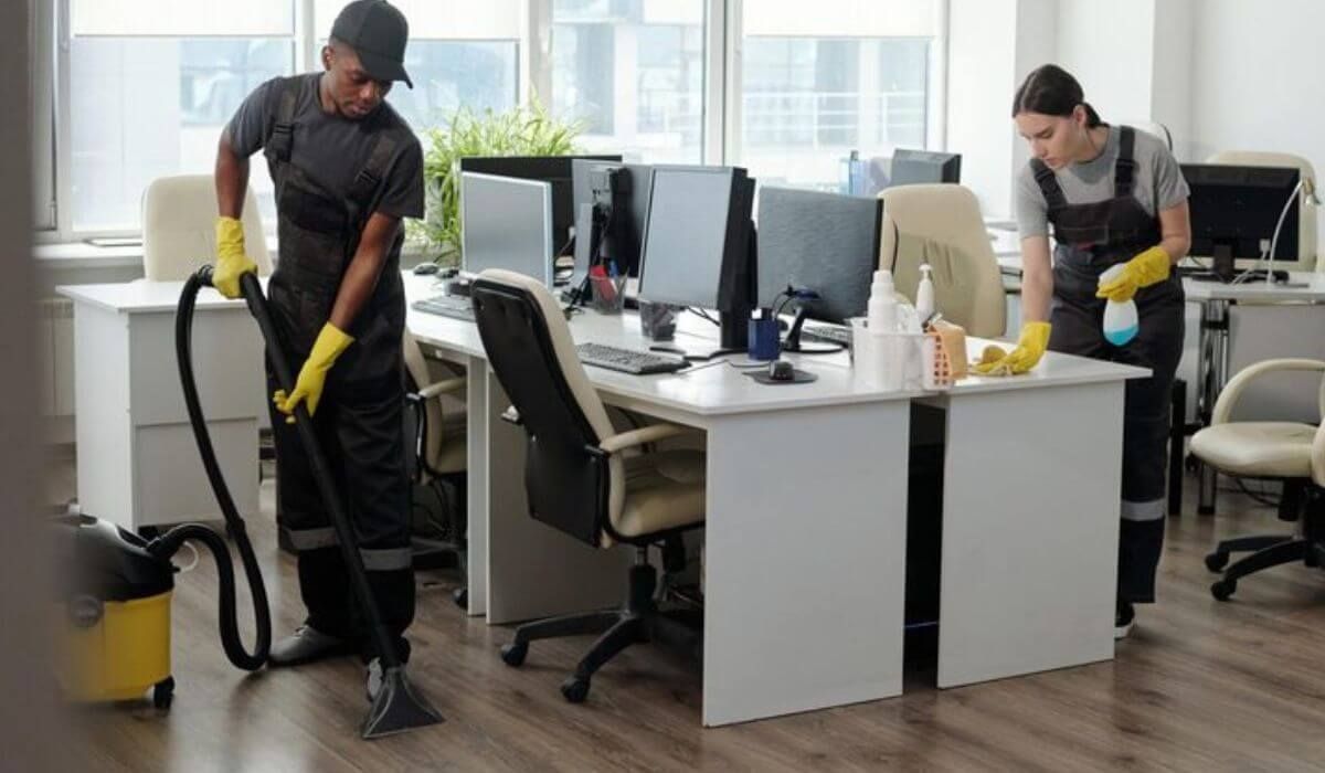 employee cleaning meeting room