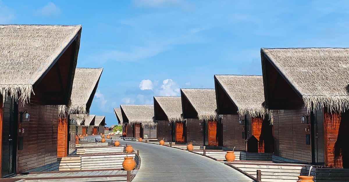 Luxury Maldives island resort with overwater villas and turquoise lagoon