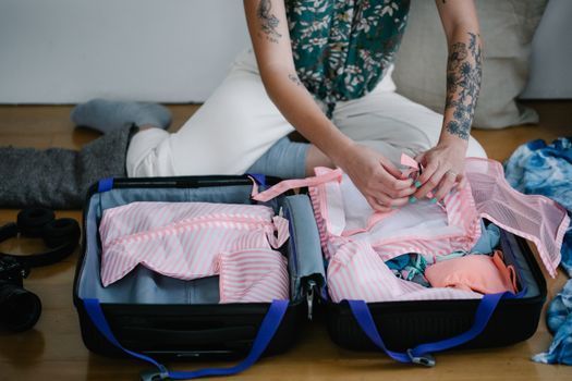 Open suitcase with Maldives holiday essentials beside a turquoise lagoon