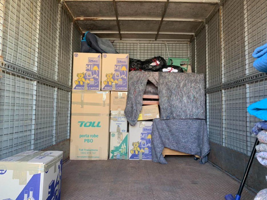 The Inside of a Moving Truck Filled With Boxes and a Mop — Buck Removals & Storage in Forbes, NSW