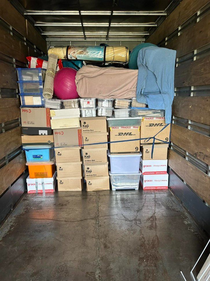 The Inside of a Moving Truck Filled With Boxes and a Bed— Buck Removals & Storage in Dubbo, NSW