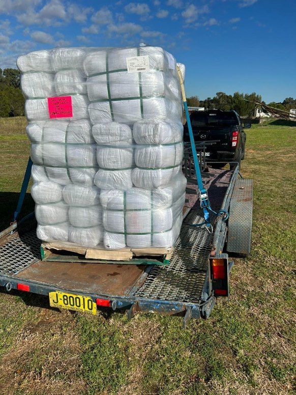A Large Stack of Clothes is Sitting on Top of a Trailer — Buck Removals & Storage in Bathurst, NSW