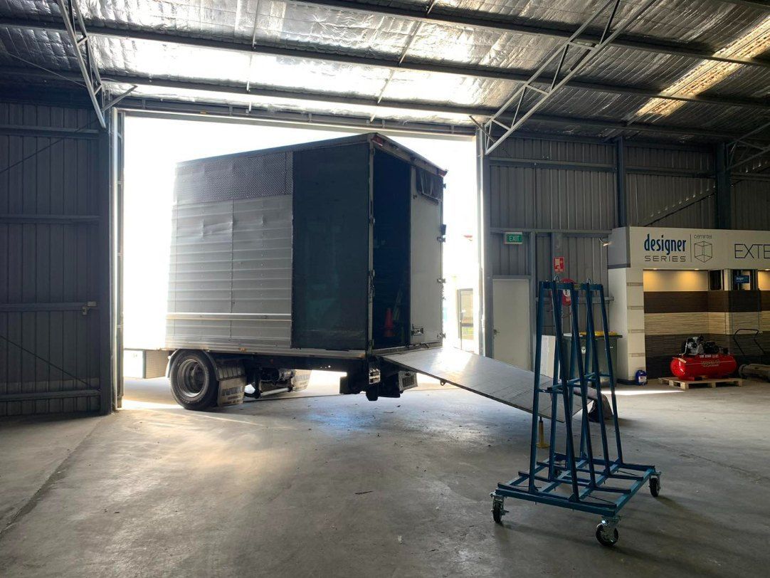 A Truck is Being Loaded Into a Warehouse With a Ramp — Buck Removals & Storage in Cowra, NSW