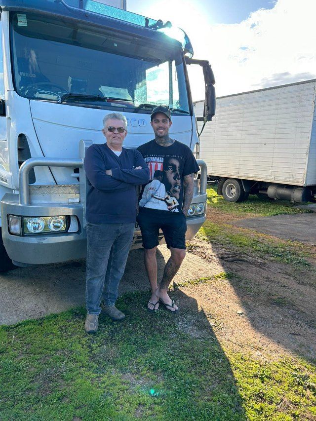 Two Men Are Standing in Front of a Truck — Buck Removals & Storage in Cowra, NSW