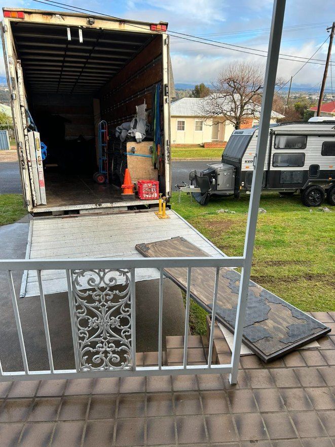 A Moving Truck is Parked in Front of a House — Buck Removals & Storage in Cowra, NSW