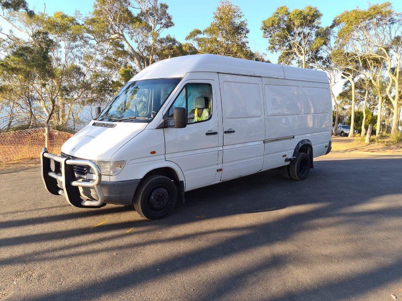A White Van is Parked on the Side of the Road — Buck Removals & Storage in Orange, NSW
