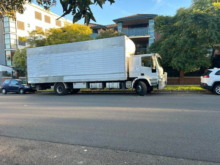 A White Truck is Parked on the Side of the Road — Buck Removals & Storage in Orange, NSW