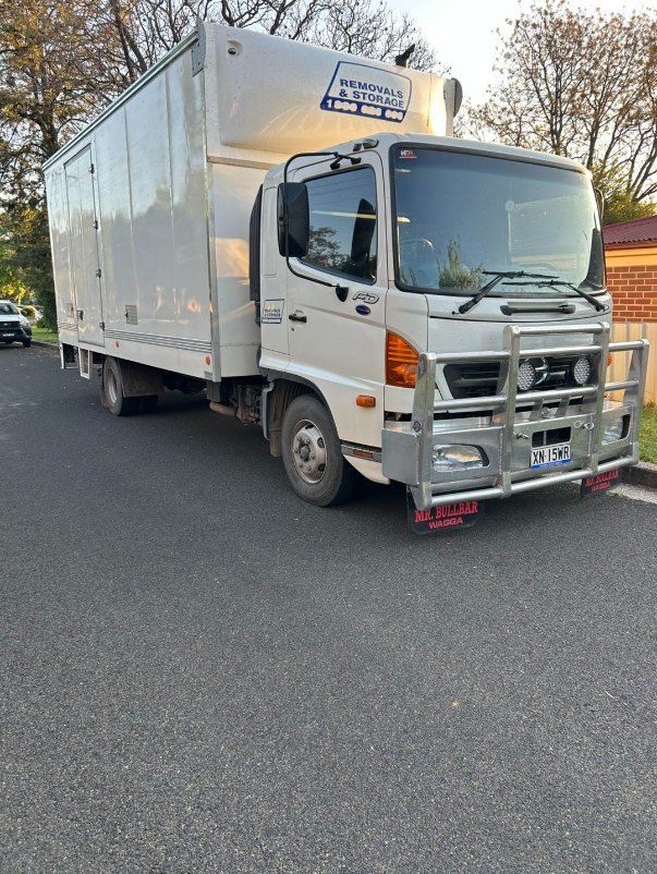 A White Moving Truck is Parked on the Side of the Road — Buck Removals & Storage in Cowra, NSW
