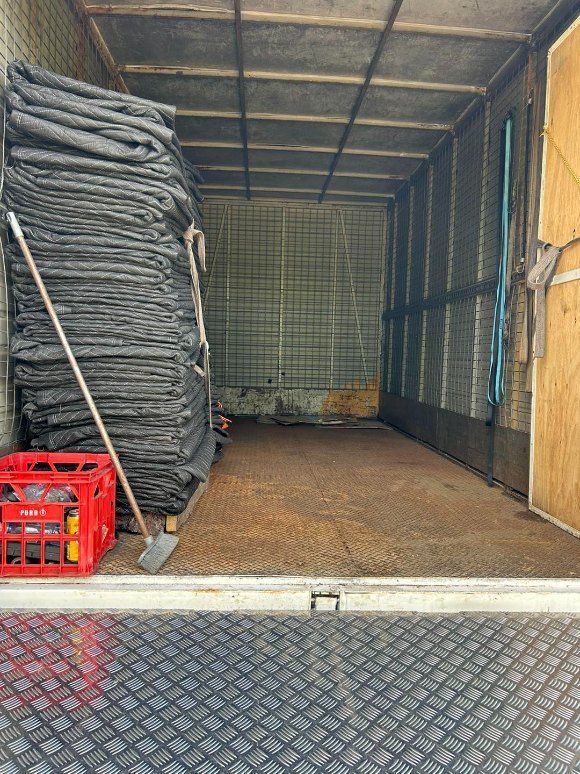 The Inside of a Truck With a Stack of Blankets and a Red Crate — Buck Removals & Storage in Forbes, NSW