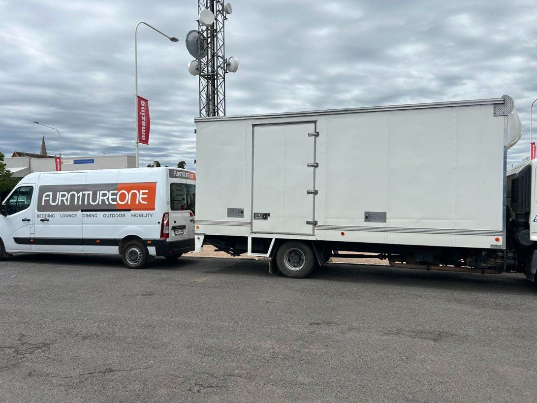 Two White Vans Are Parked Next to Each Other in a Parking Lot — Buck Removals & Storage in Young, NSW