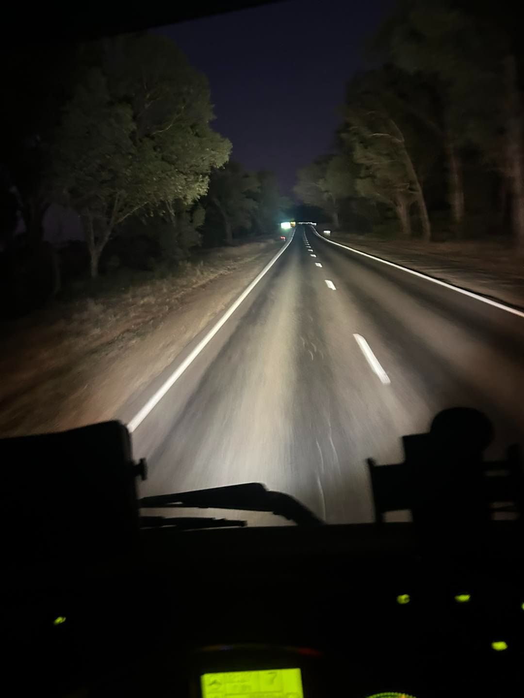 A Car is Driving Down a Highway at Night — Buck Removals & Storage in Cowra, NSW