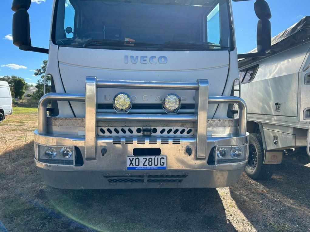A White Truck With a Chrome Bumper is Parked in a Parking Lot — Buck Removals & Storage in Wagga Wagga, NSW