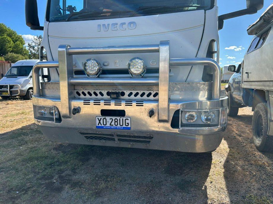 A White Iveco Truck is Parked in a Dirt Lot — Buck Removals & Storage in Griffith, NSW