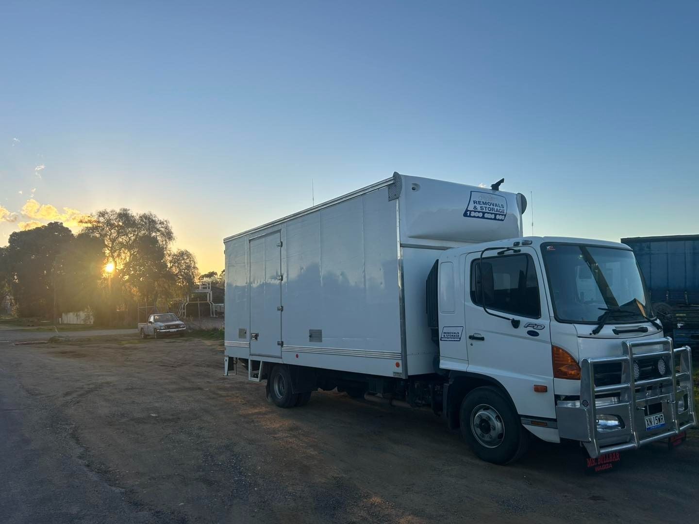White Removalist Truck Parked at Open Area