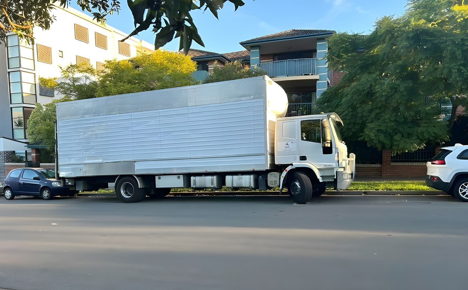 A Large Moving Truck Parked On A Residential Street