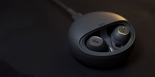 Black Earbuds in a Charging Case on a Dark Surface — Phone Hut in Alice Springs, NT