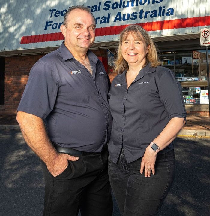 Two People Standing in Front of a Store — Phone Hut in Alice Springs, NT