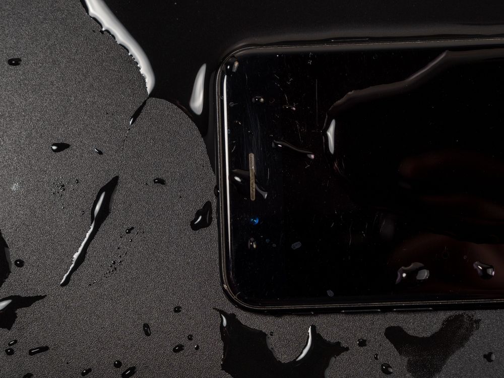 Black Cell Phone With Water Spilled on It — Phone Hut in Alice Springs, NT