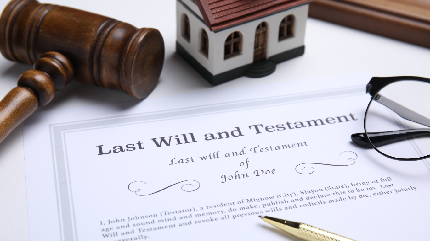Will and testament document with gavel, house model, eyeglasses, and pen on a white desk