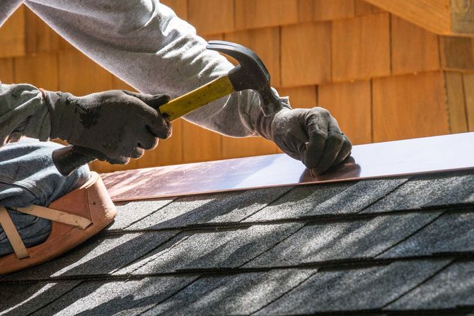 A man is working on a roof with a hammer