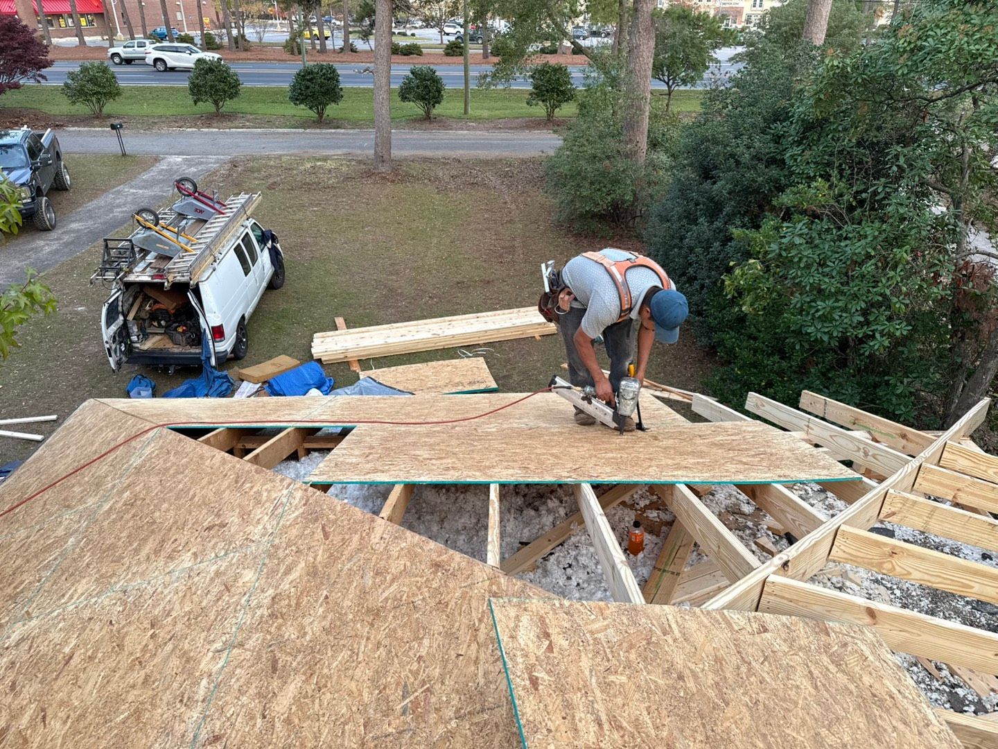 A man is working on the roof of a house.