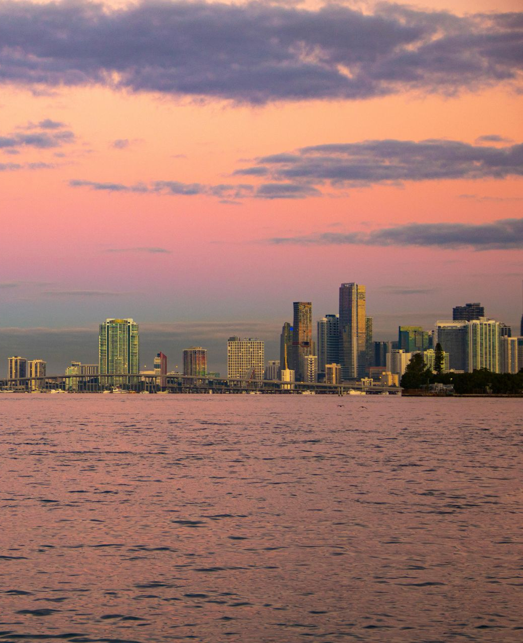 A folder filled with papers is sitting on a wooden table.