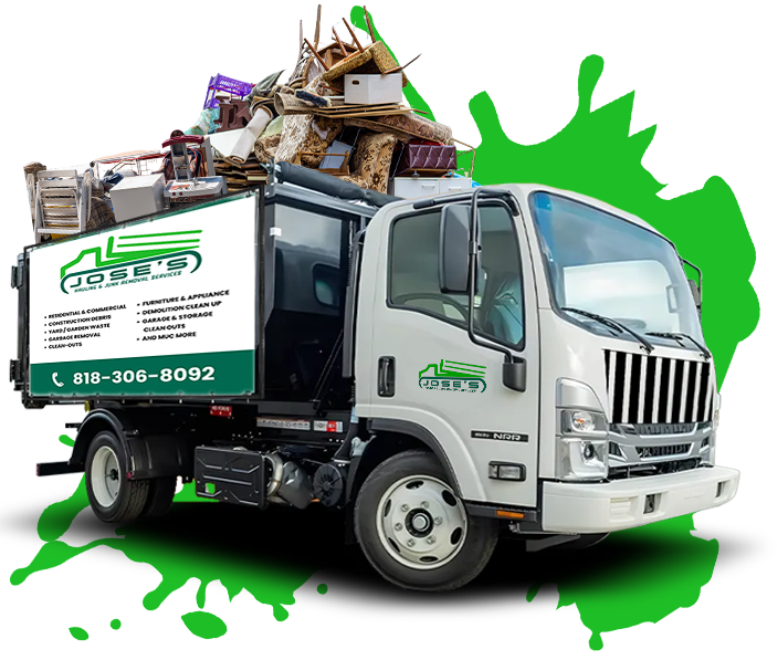 A garbage truck with a bunch of trash on top of it.