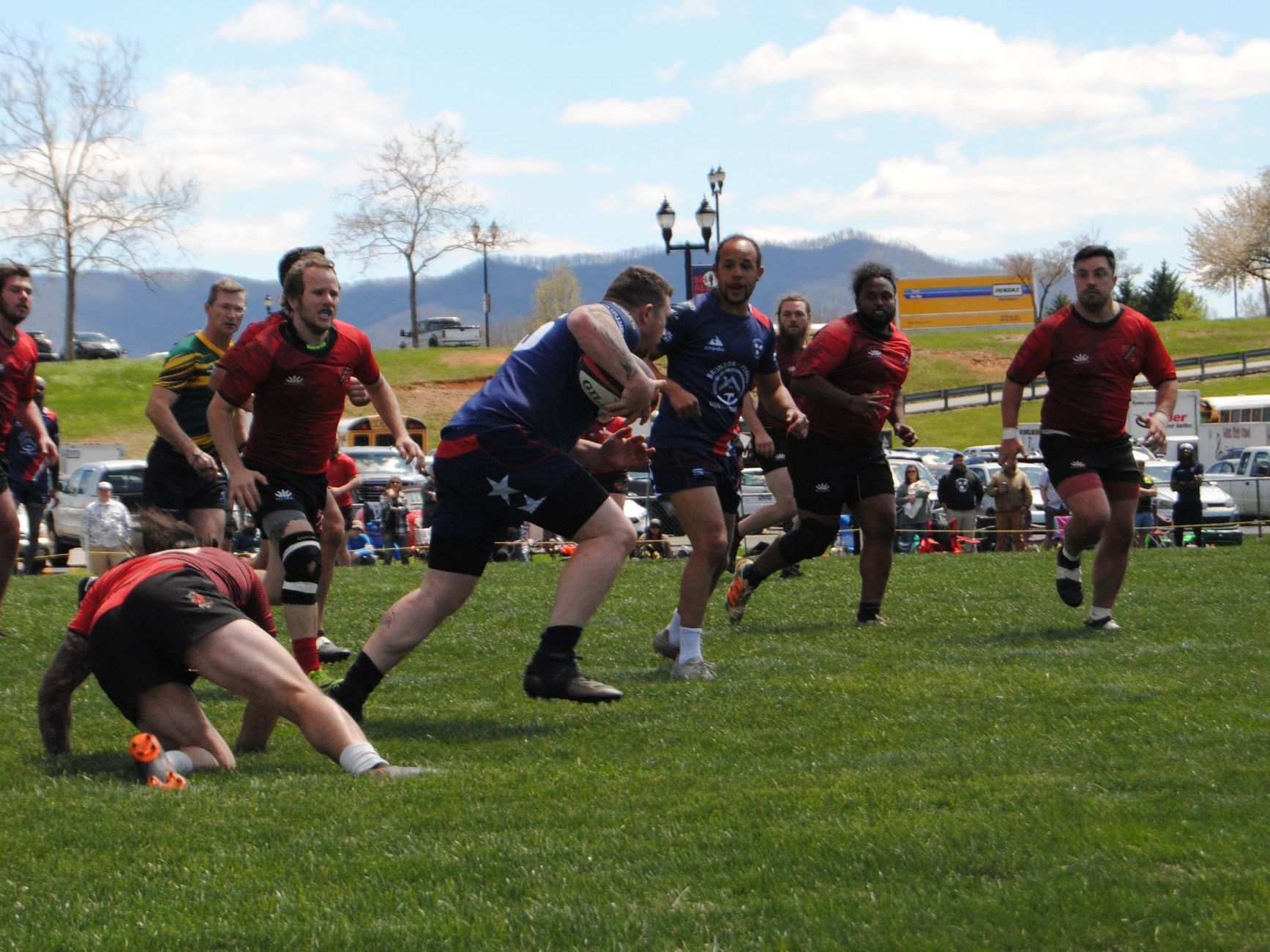 A group of men are playing rugby on a field