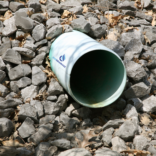 A white barrel with a blue logo on it sits on a pile of rocks