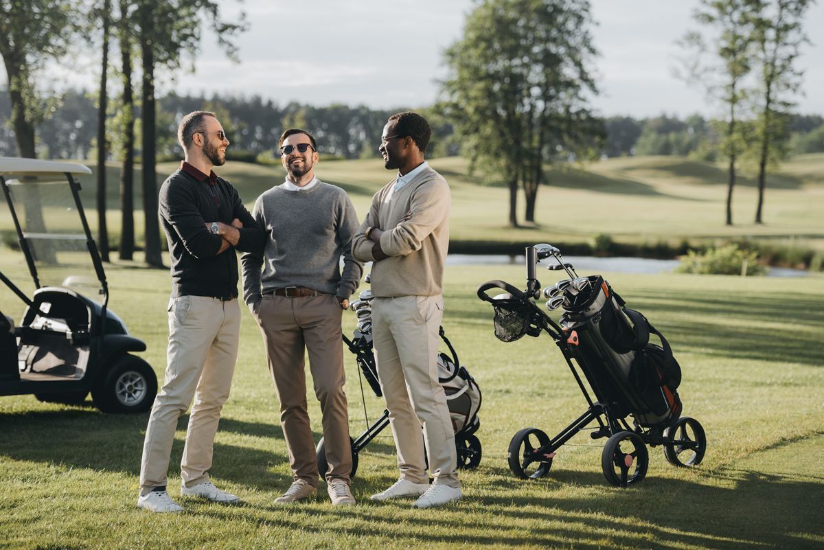 Three men talking on the golf course