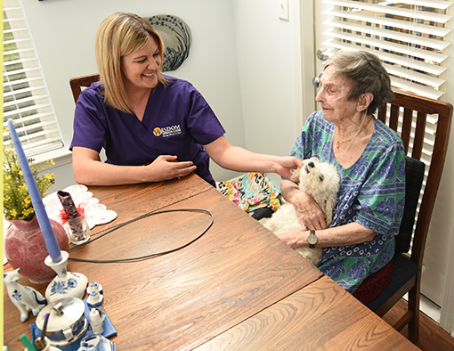 Nurse assisting an elderly person using a walker in a brightly lit hallway. Nurse assisting an elderly person using a walker in a brightly lit hallway.