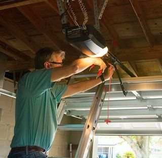 Technician repairing — Garage Door Repair Services in Flagstaff, AZ