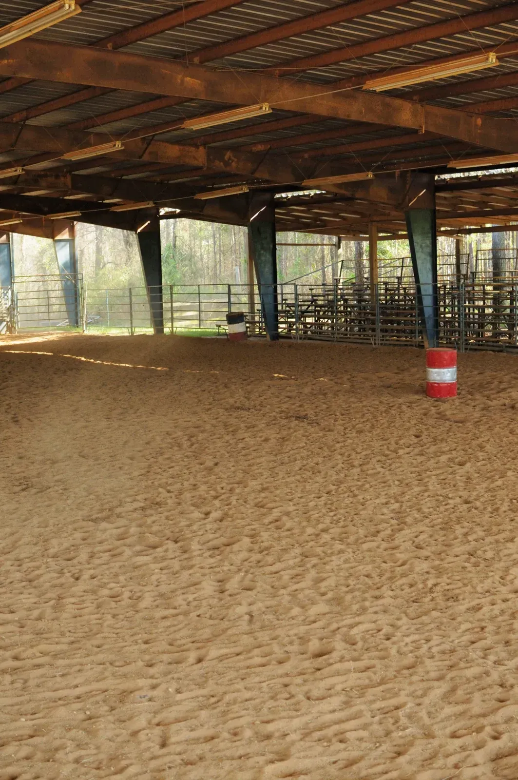 An empty arena with a red and white barrel in the middle