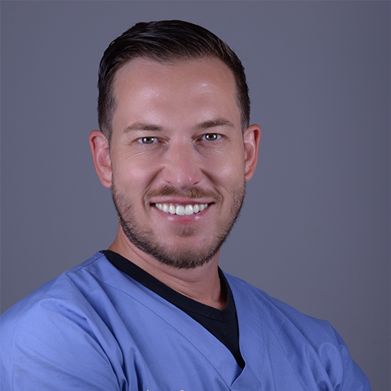 Dr. Lenhoff in a blue scrub top is smiling for the camera.