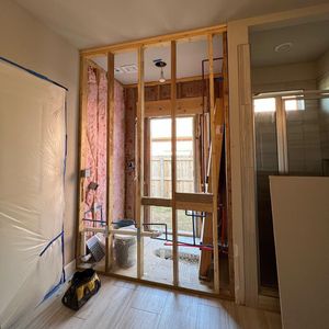 A room that is being remodeled with a toolbox on the floor