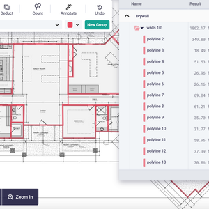 A computer screen shows measuring a floor plan of a house