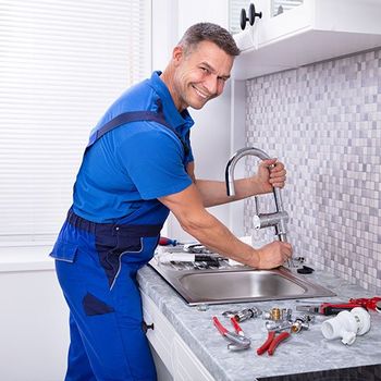 Plumber Installing Faucet in Kitchen — Delaware, OH — Wells Septic & Drain Cleaning