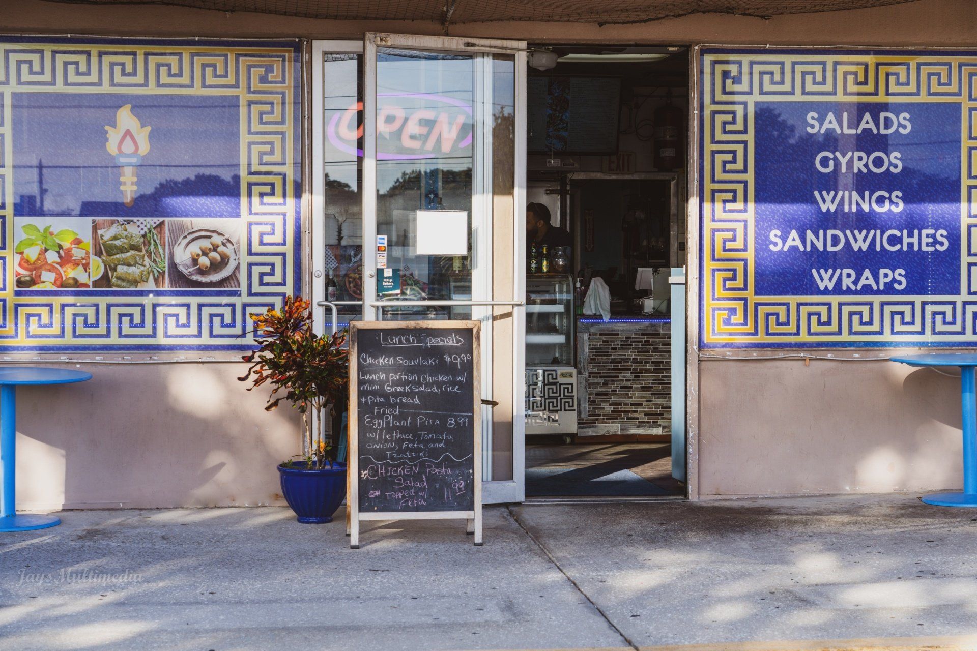 A restaurant that sells salads gyros wings sandwiches and wraps